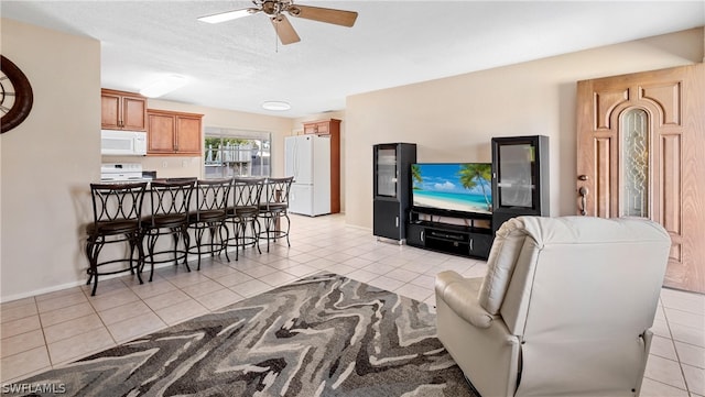 tiled living room featuring ceiling fan