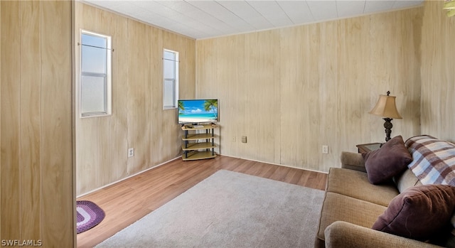 living room with wooden walls and light wood-type flooring