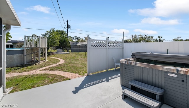 view of terrace with a hot tub