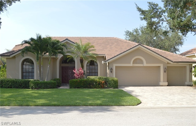 view of front of home featuring a garage and a front lawn