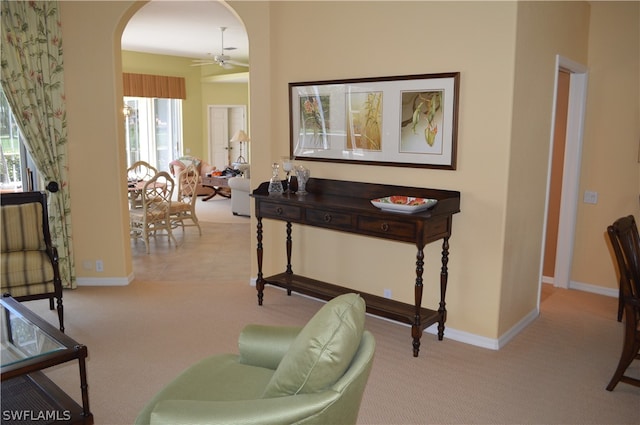 living area featuring ceiling fan and carpet flooring