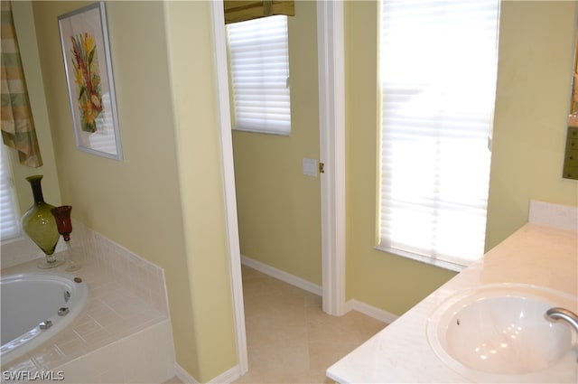 bathroom featuring a relaxing tiled bath, vanity, and tile floors