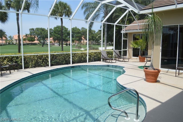 view of swimming pool featuring a patio and glass enclosure