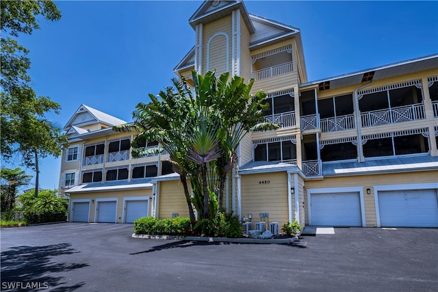 view of front facade featuring a garage and a balcony