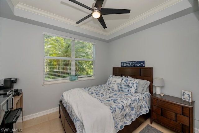 bedroom with ornamental molding, ceiling fan, and a raised ceiling