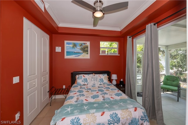 bedroom with tile floors, ceiling fan, a closet, and crown molding