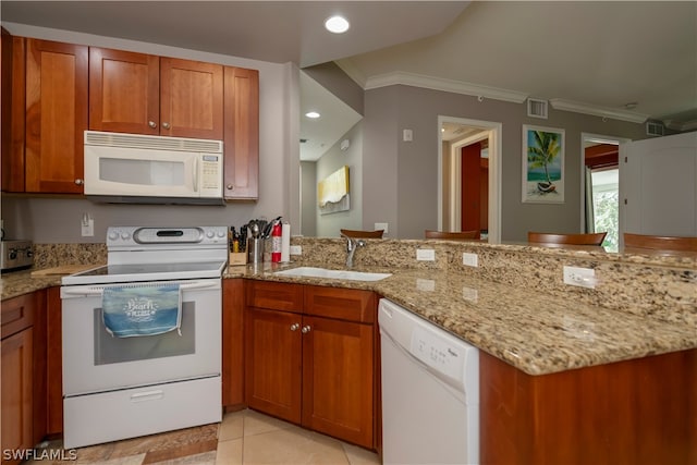 kitchen with crown molding, white appliances, light stone counters, sink, and light tile floors