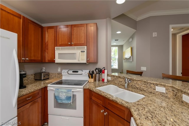 kitchen featuring light stone countertops, sink, crown molding, and white appliances