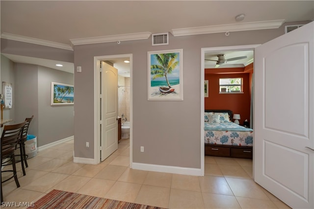 interior space with crown molding and light tile floors