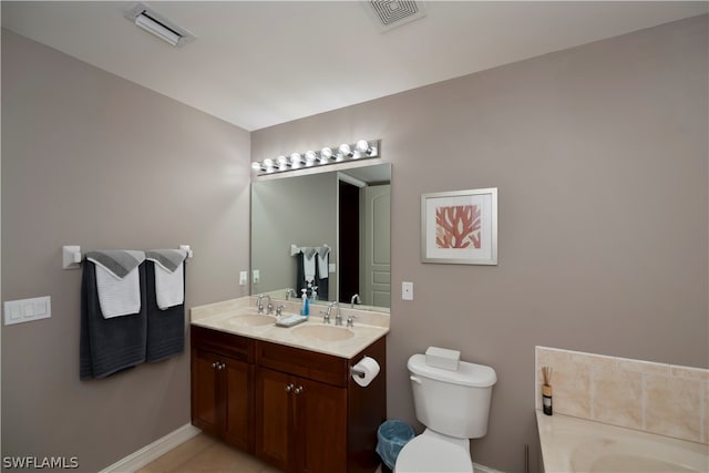 bathroom with double vanity, toilet, tile floors, and a bathing tub