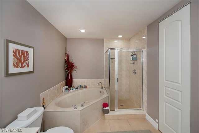 bathroom featuring toilet, tile floors, and plus walk in shower