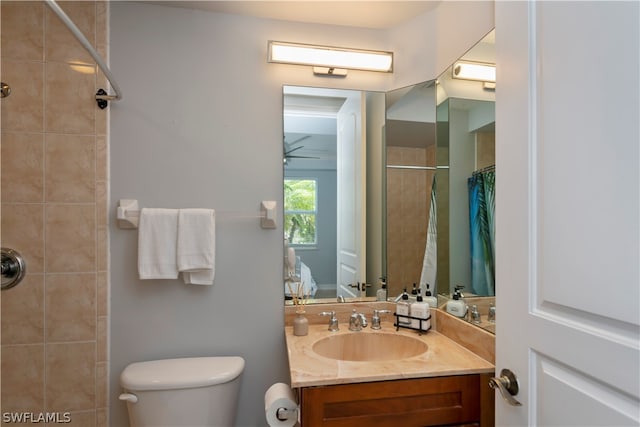 bathroom with ceiling fan, toilet, and vanity