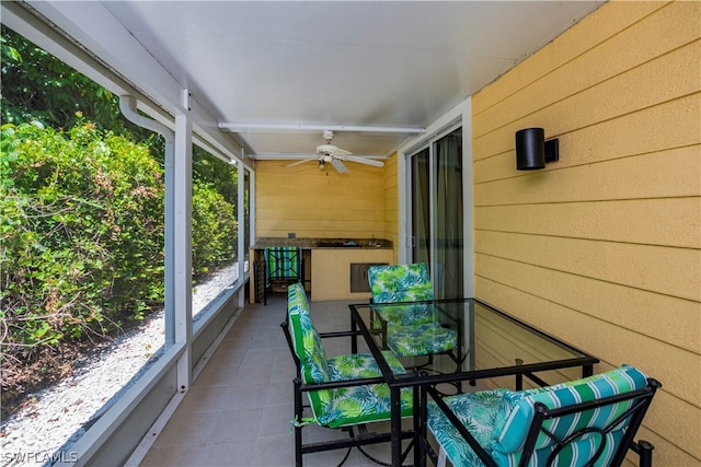 sunroom featuring ceiling fan