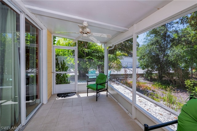 unfurnished sunroom featuring ceiling fan