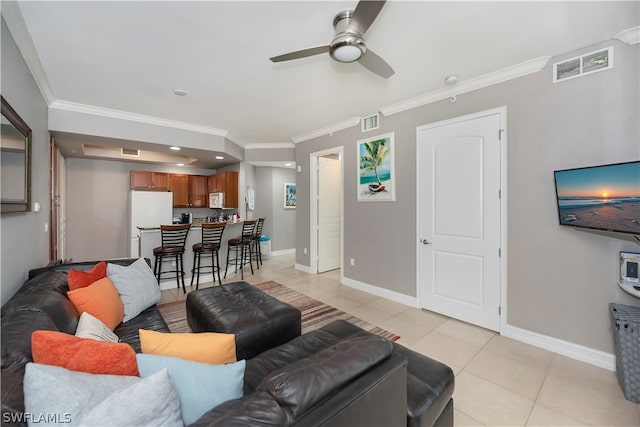 tiled living room featuring ceiling fan and crown molding