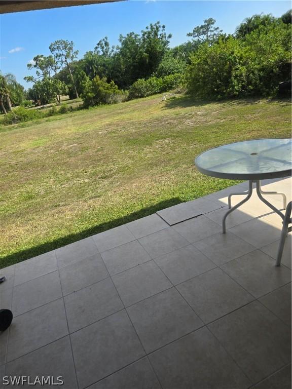 466 Redwing St, Lehigh Acres, FL 33974 - view of green lawn featuring a patio