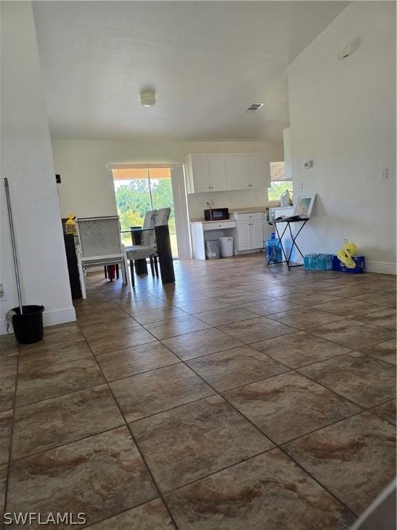 466 Redwing St, Lehigh Acres, FL 33974 - dining area with plenty of natural light, baseboards, and dark tile patterned flooring