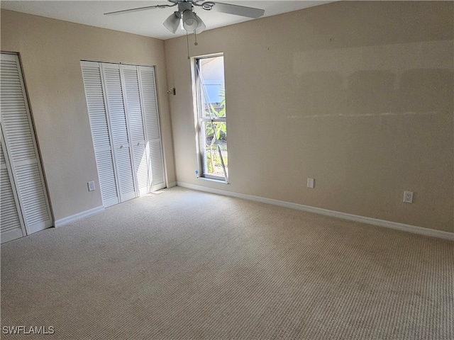 unfurnished bedroom featuring light carpet and ceiling fan