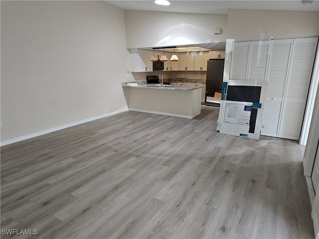 living room with sink, high vaulted ceiling, and light wood-type flooring