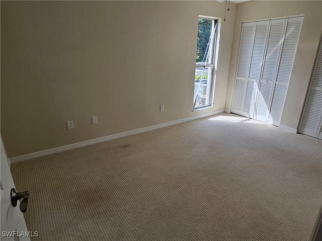 unfurnished bedroom featuring a closet and carpet