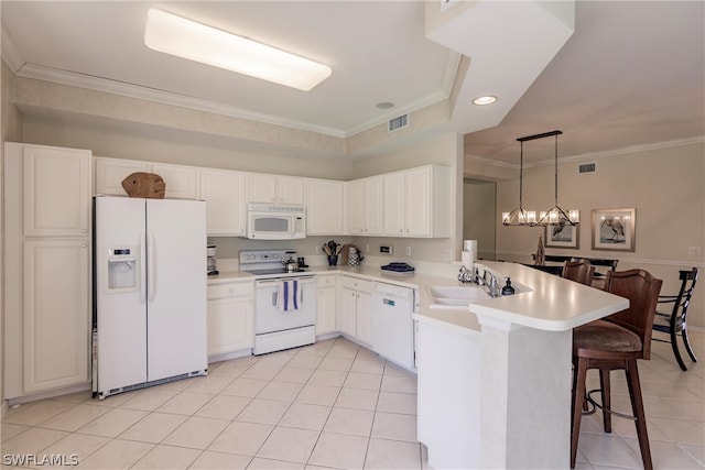 kitchen with ornamental molding, kitchen peninsula, white appliances, and sink