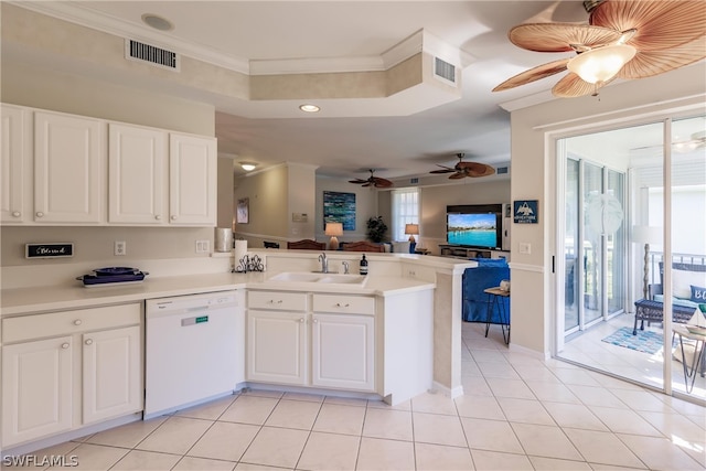 kitchen featuring a healthy amount of sunlight, ceiling fan, white dishwasher, and kitchen peninsula