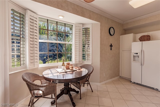 dining room featuring ornamental molding and light tile flooring