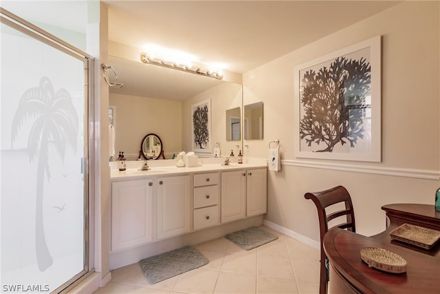 bathroom featuring tile flooring, a shower with shower door, and double sink vanity