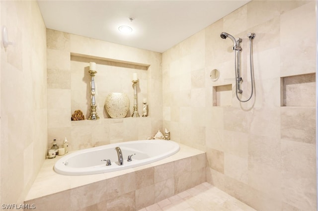 bathroom with tile walls and independent shower and bath