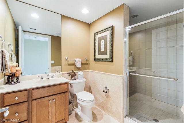 bathroom with toilet, tile patterned flooring, a shower with shower door, and vanity