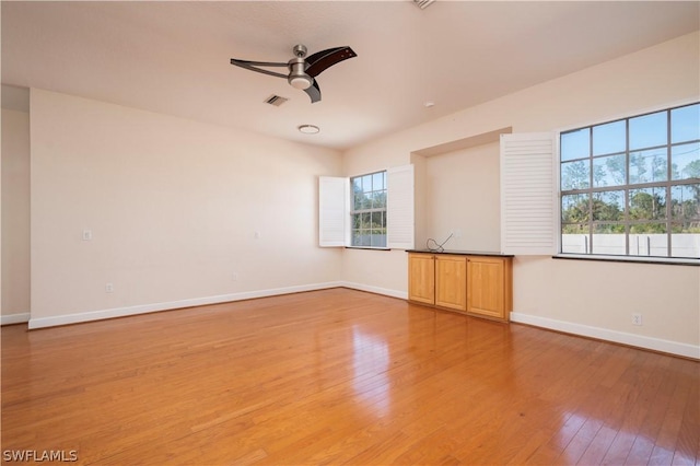 empty room featuring ceiling fan and light hardwood / wood-style floors