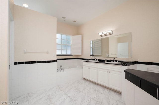 bathroom with vanity and a tub