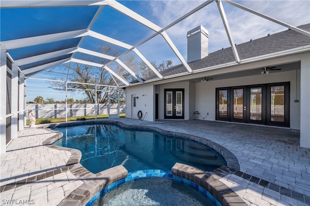 view of pool with french doors, ceiling fan, a lanai, an in ground hot tub, and a patio area