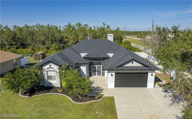 view of front of house featuring a front yard and a garage