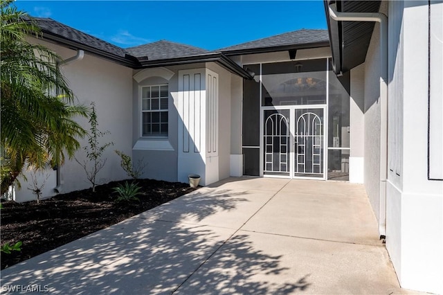 view of exterior entry with a patio