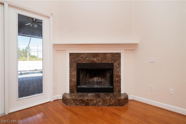 interior details with hardwood / wood-style flooring, a fireplace, and ceiling fan