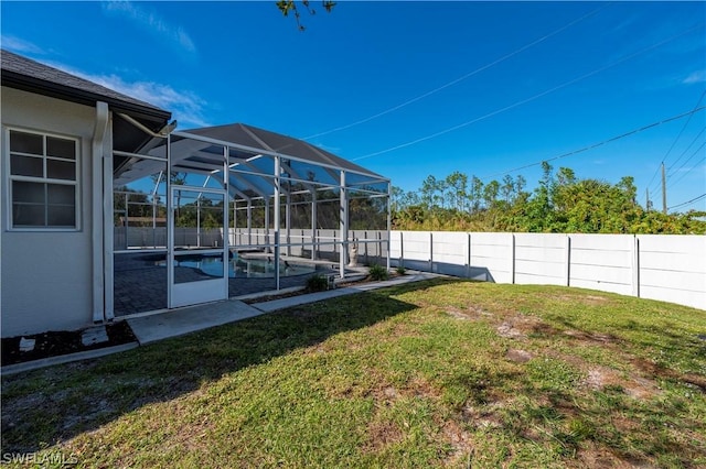 view of yard with a fenced in pool and a lanai