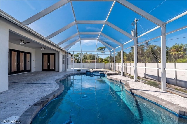 view of pool featuring a lanai, a patio area, ceiling fan, and french doors