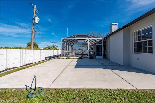 view of patio featuring a lanai