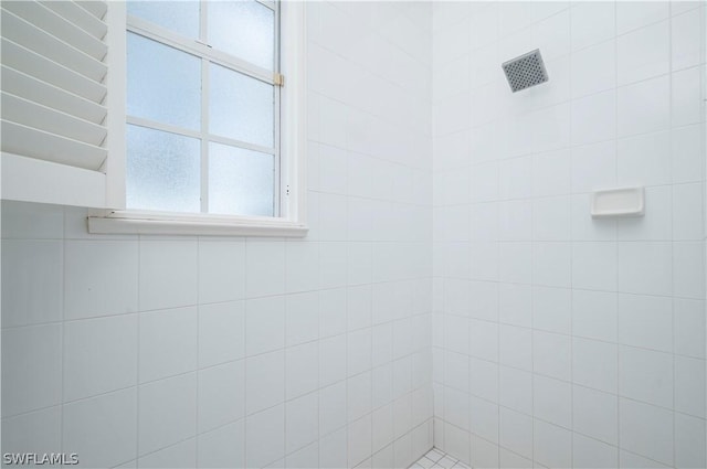 bathroom with tiled shower