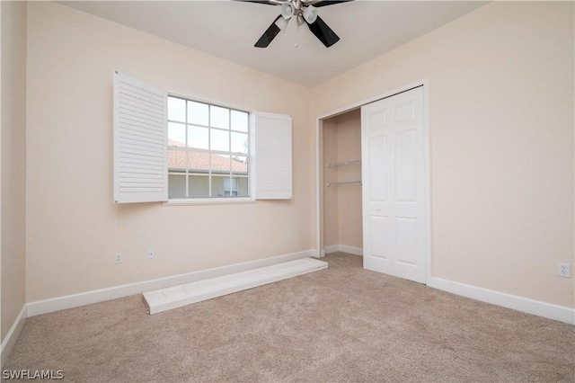 unfurnished bedroom with light carpet, a closet, and ceiling fan