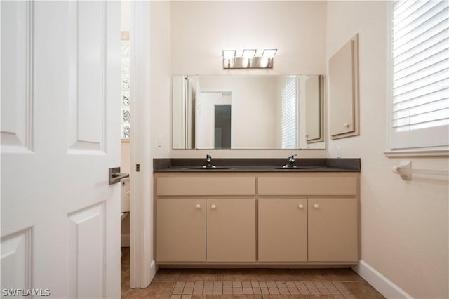 bathroom featuring tile patterned flooring and vanity