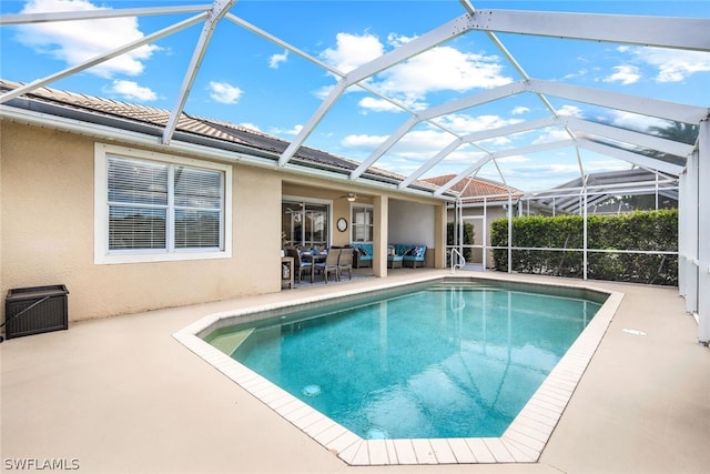 view of pool with a lanai and a patio