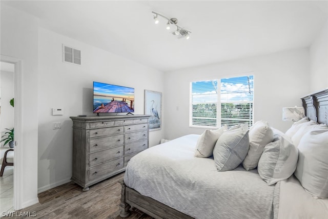 bedroom with hardwood / wood-style flooring