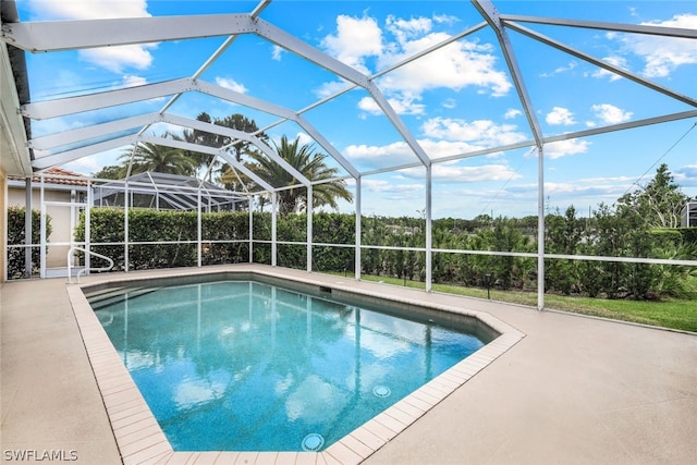 view of pool with a lanai and a patio