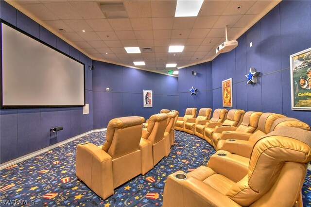 home theater featuring a drop ceiling and carpet floors