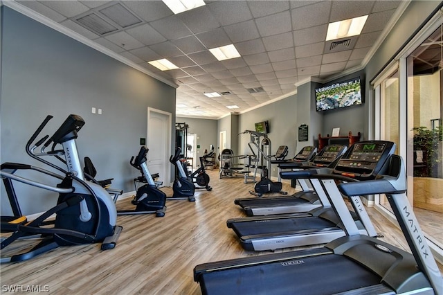 gym featuring a drop ceiling, visible vents, wood finished floors, and crown molding