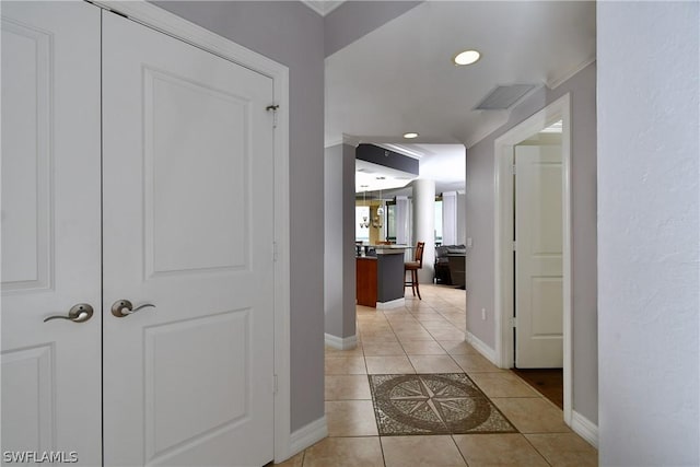 hallway featuring recessed lighting, visible vents, baseboards, and light tile patterned flooring