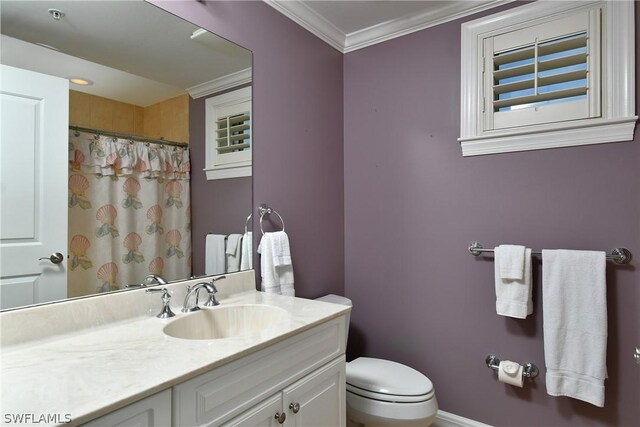 bathroom featuring crown molding, vanity, and toilet