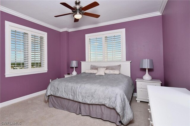 carpeted bedroom with ceiling fan and crown molding